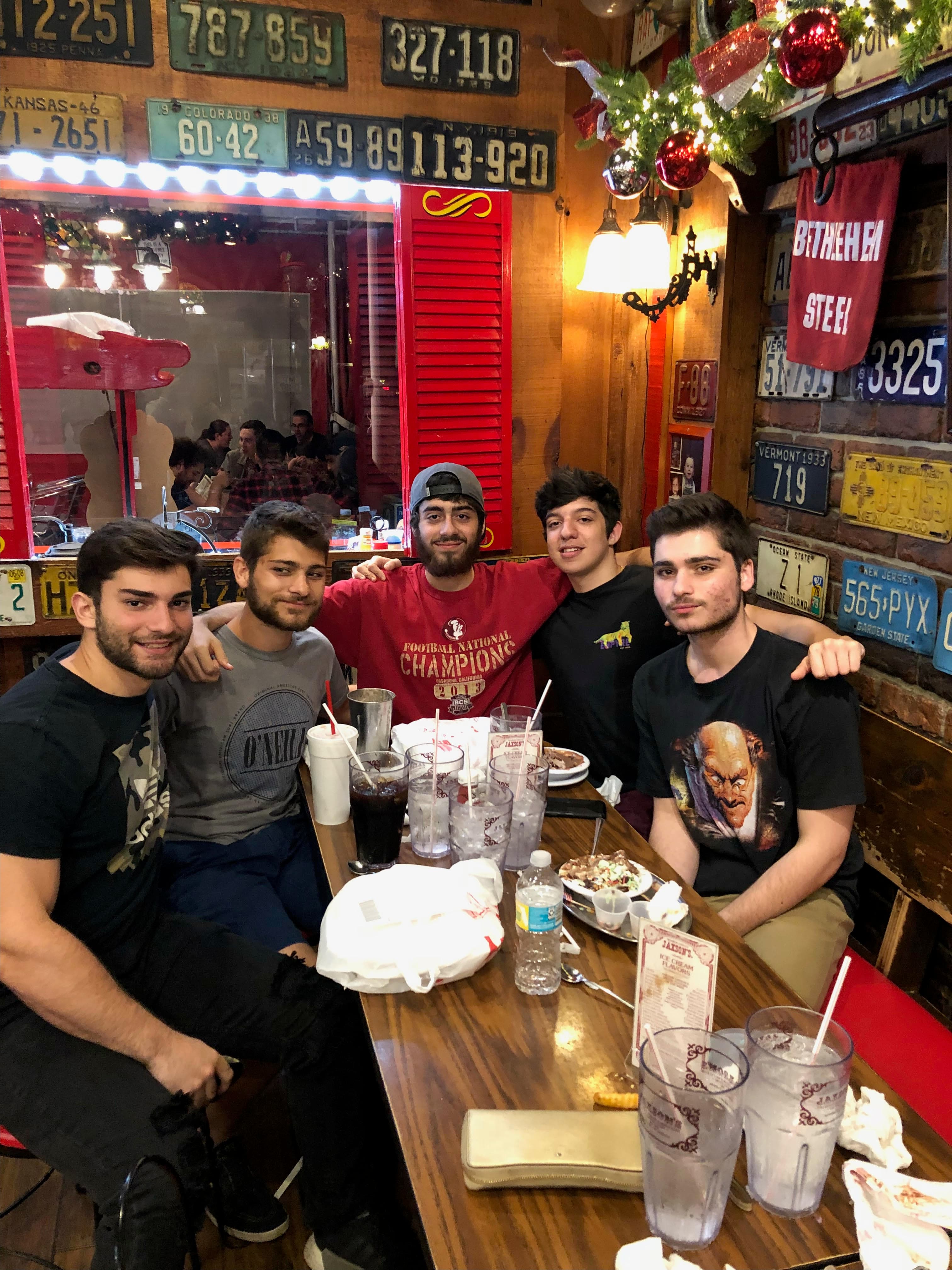 Ryan and friends at a restaurant covered in license plates